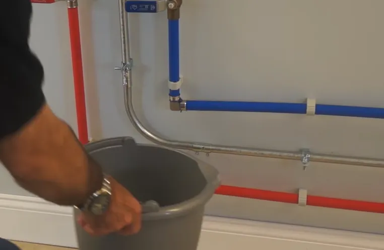 Placing a plastic bucket under the cold water side