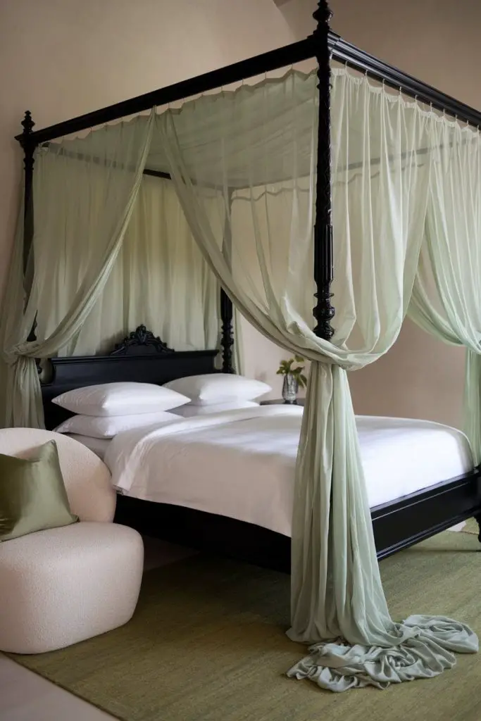 Black Four-Poster Bed with Sage Green Sheer Curtains