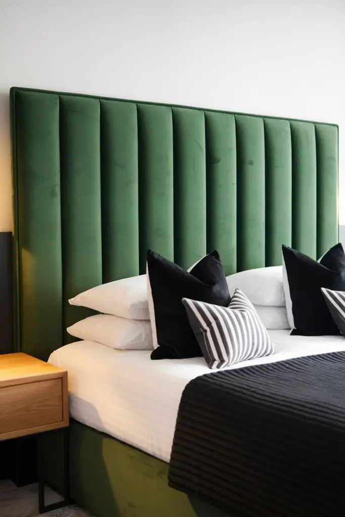 Green Headboard with Black Accent Pillows